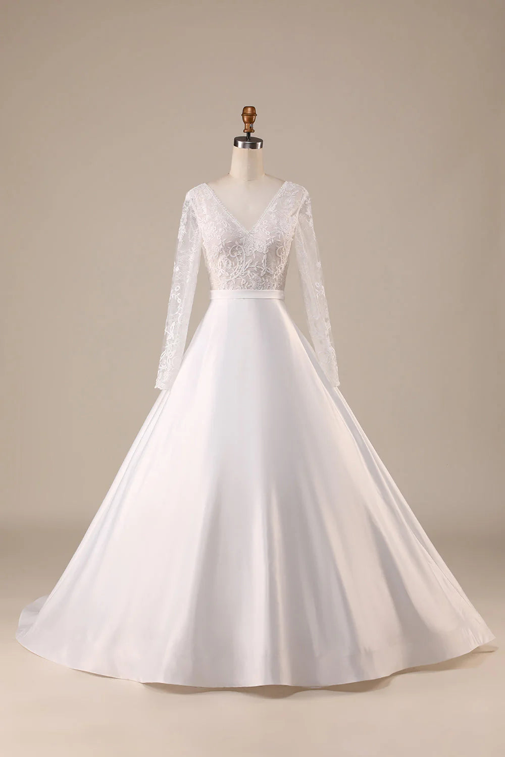 Ivory satin wedding dress with V-neck and long sleeves, featuring a sweep train.