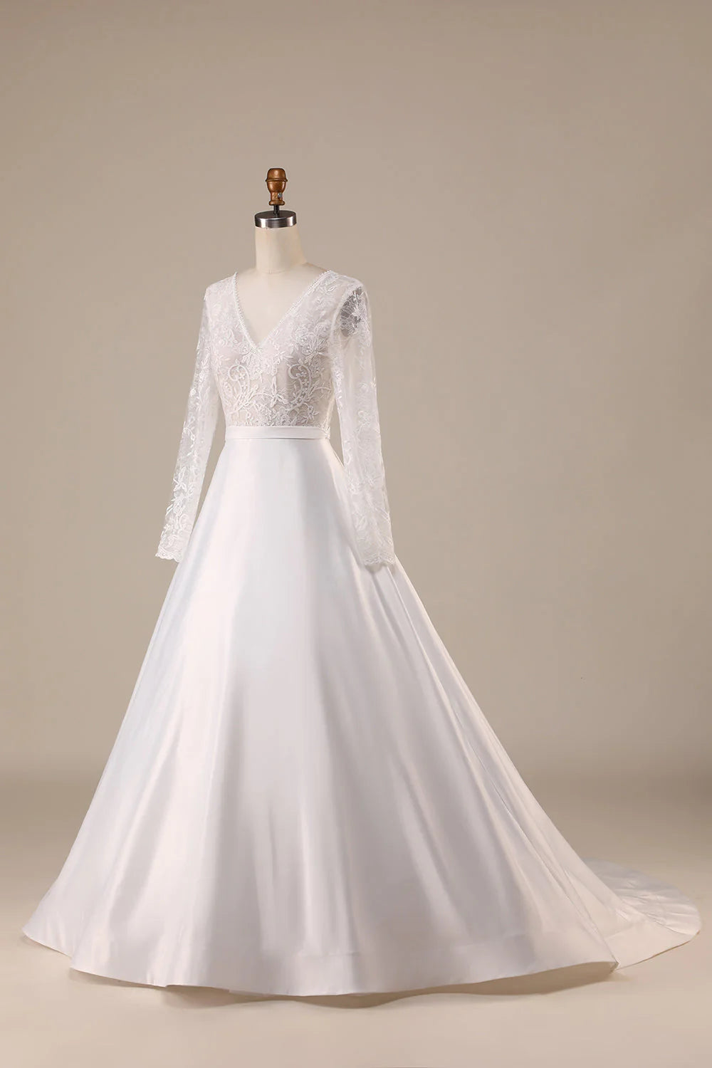 Close-up of the V-neckline and long sleeves on an ivory satin bridal gown.