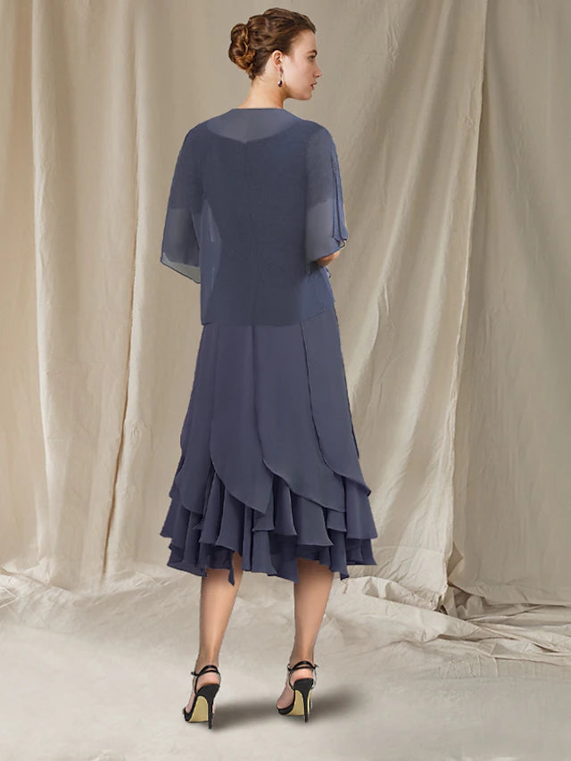 Back view of the mermaid tea length dress, showcasing the high-low hem and lace ruffles.