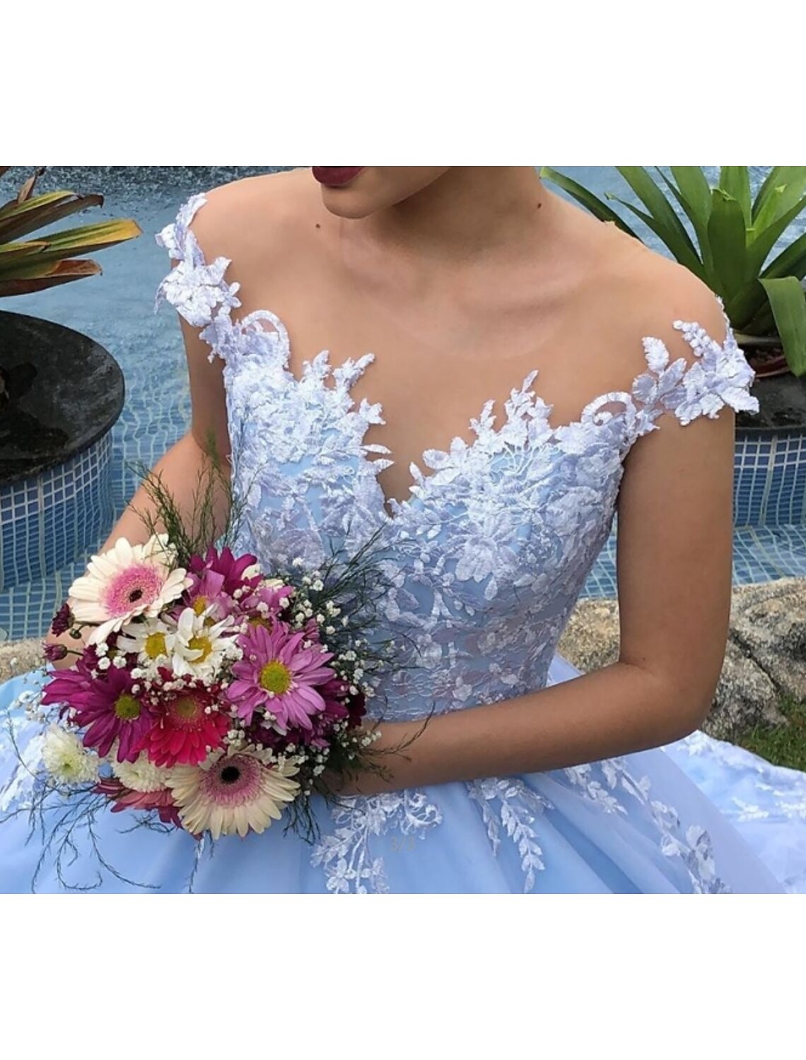 Back view of the wedding dress showcasing the chapel train and delicate lace details.