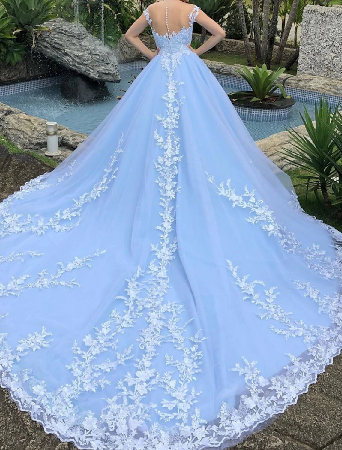 Side view of the ball gown wedding dress, highlighting the silhouette and cap sleeves.