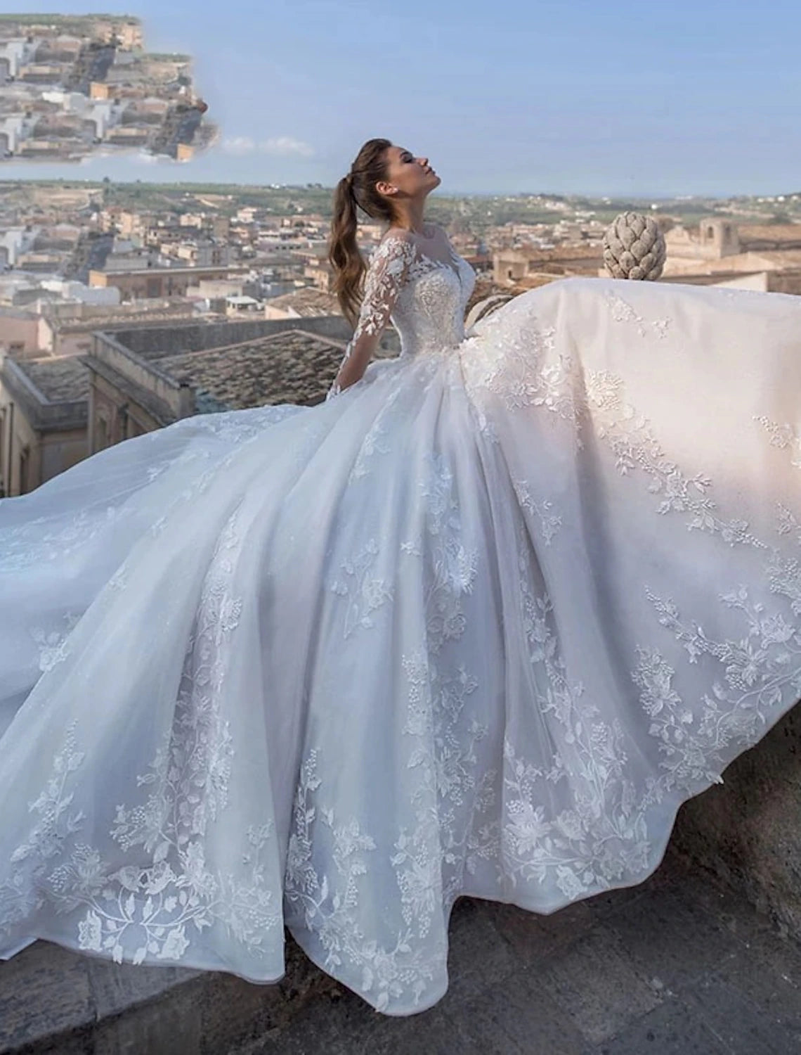 Detail of the flowing chapel train and delicate lace embellishments on the bridal gown.
