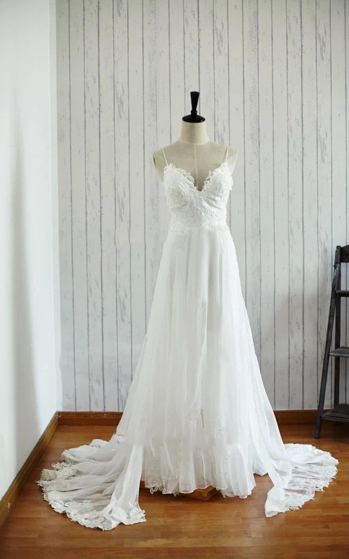 Elegant lace backless V-neck chiffon satin wedding dress with flowing skirt.