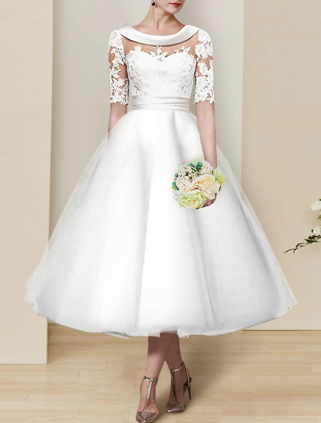 Elegant lace ball gown tea-length wedding dress with a scoop neckline, front view.