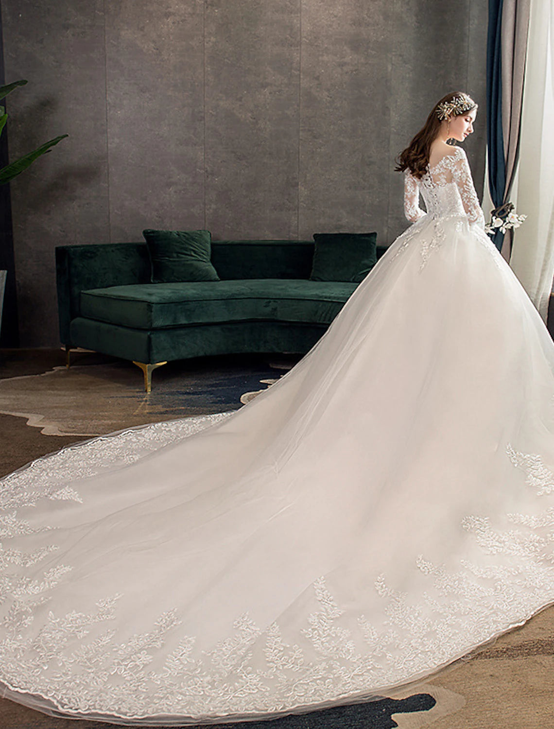 Back view of a wedding dress showcasing a long cathedral train.
