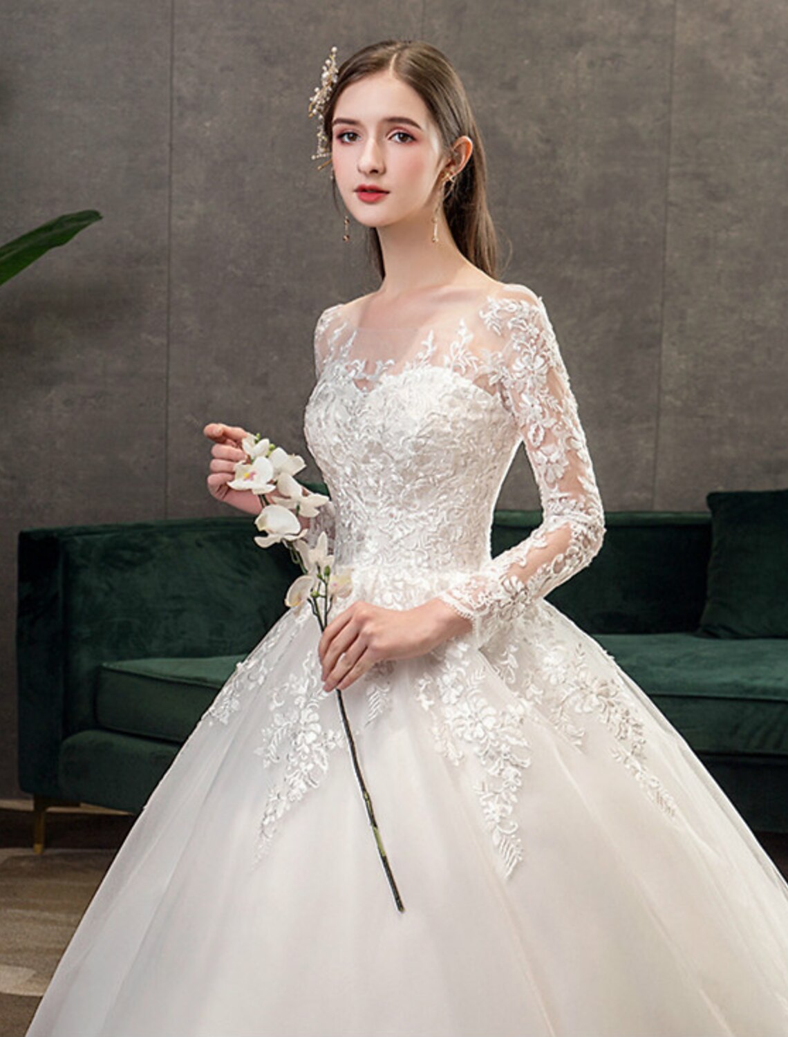 Full length view of a bride wearing a formal lace wedding dress.