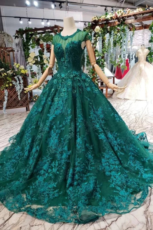 Model wearing an elegant sleeveless lace ball gown with floral beads.