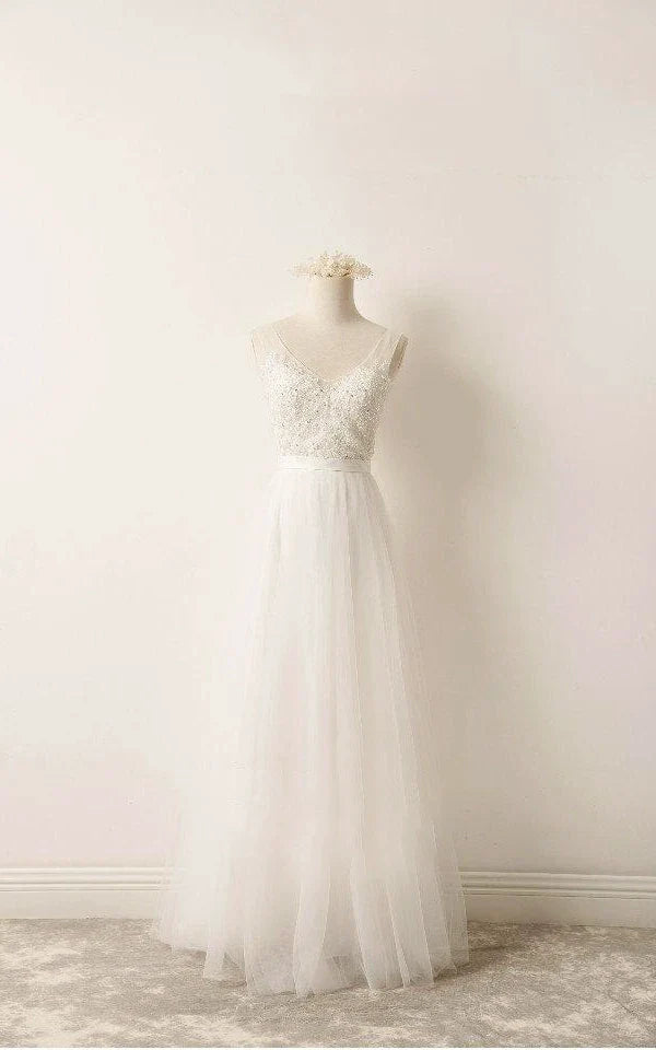 Elegant A-line lace wedding dress with intricate beading.