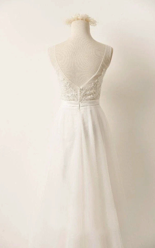 Close-up of delicate lace and beading on a bridal gown.