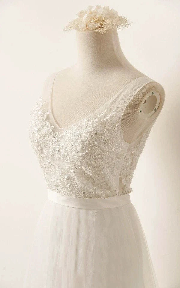 Back view of a white wedding dress featuring lace and beading details.