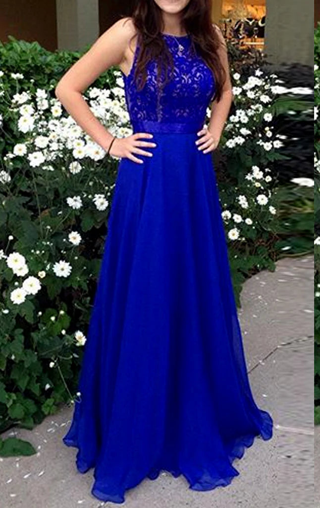 Woman posing in an elegant lace chiffon maxi prom dress with spaghetti straps.