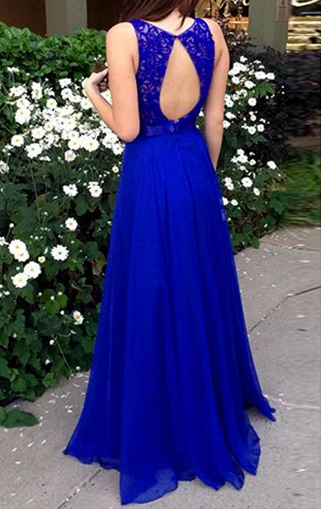 Side view of a woman wearing a flowing lace chiffon maxi prom dress with spaghetti straps.
