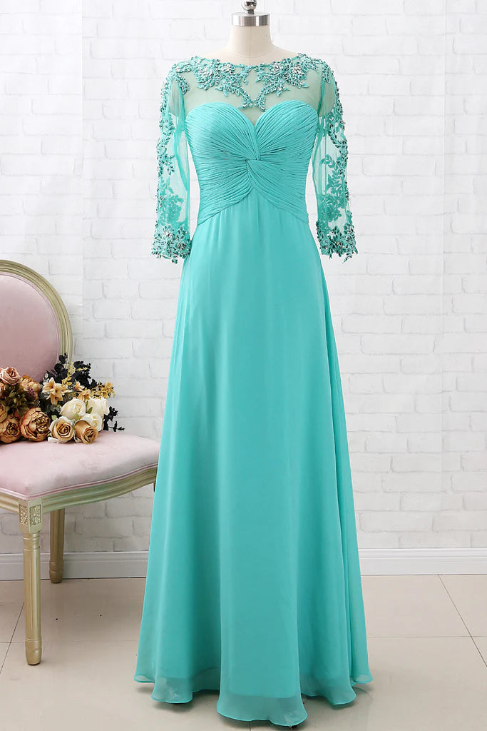 Woman wearing an elegant lace and chiffon Mother of the Bride dress with 3/4 sleeves and V-neck.