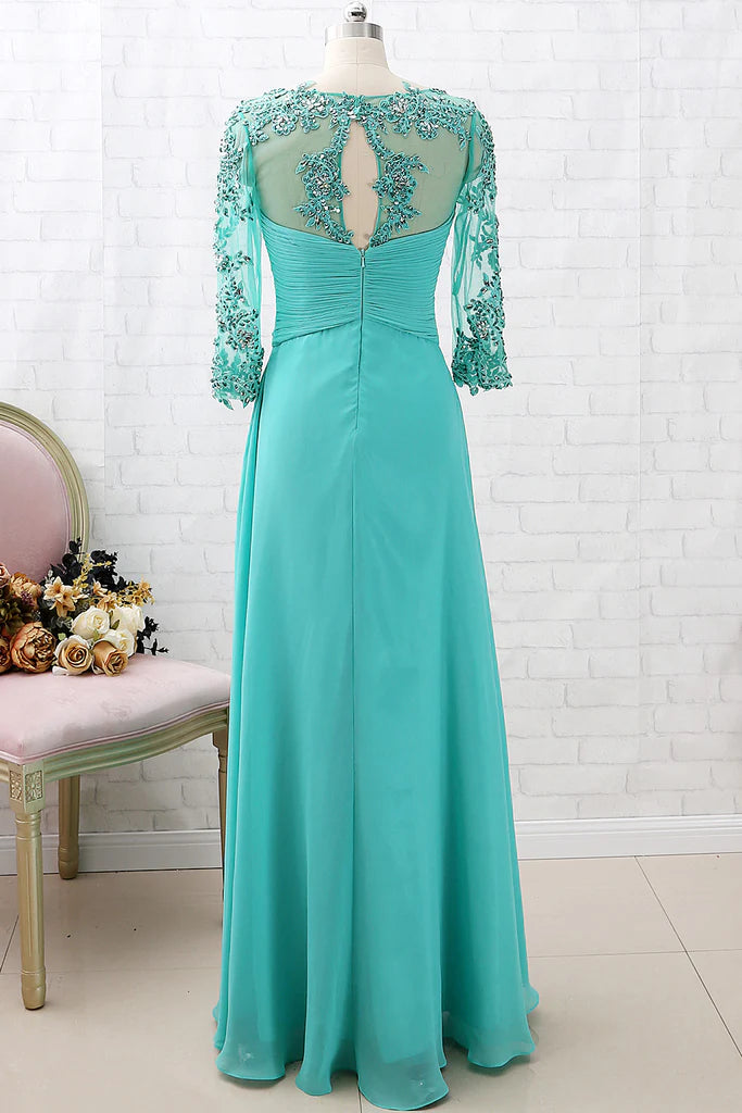 Back view of a woman in a long lace and chiffon formal gown, showcasing the elegant drape.
