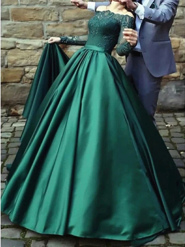 Woman wearing an elegant long sleeve lace formal prom dress.