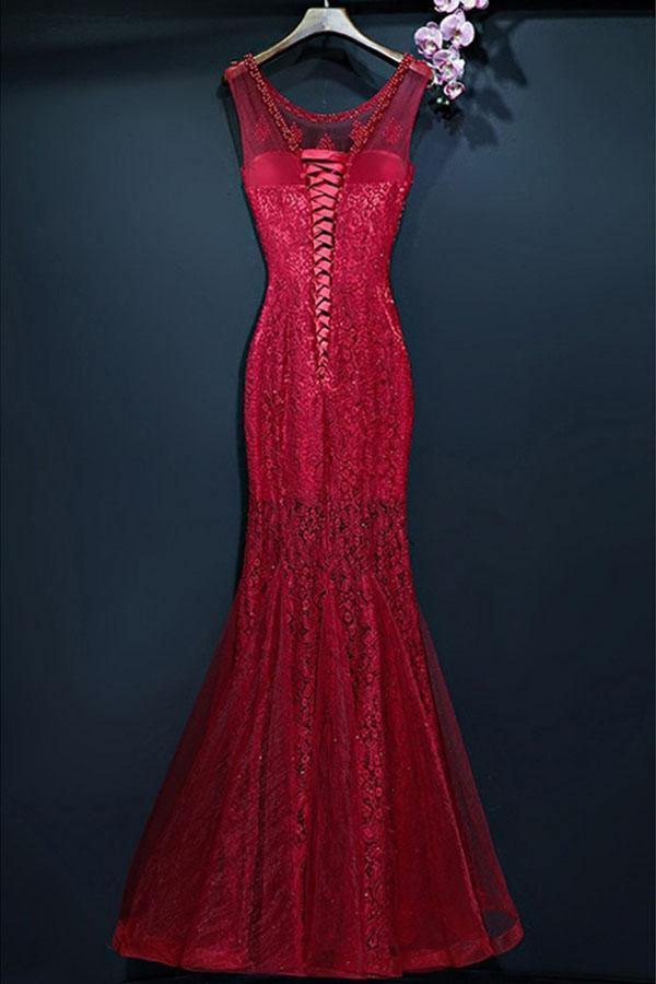 Woman posing in a sophisticated lace mermaid formal gown.