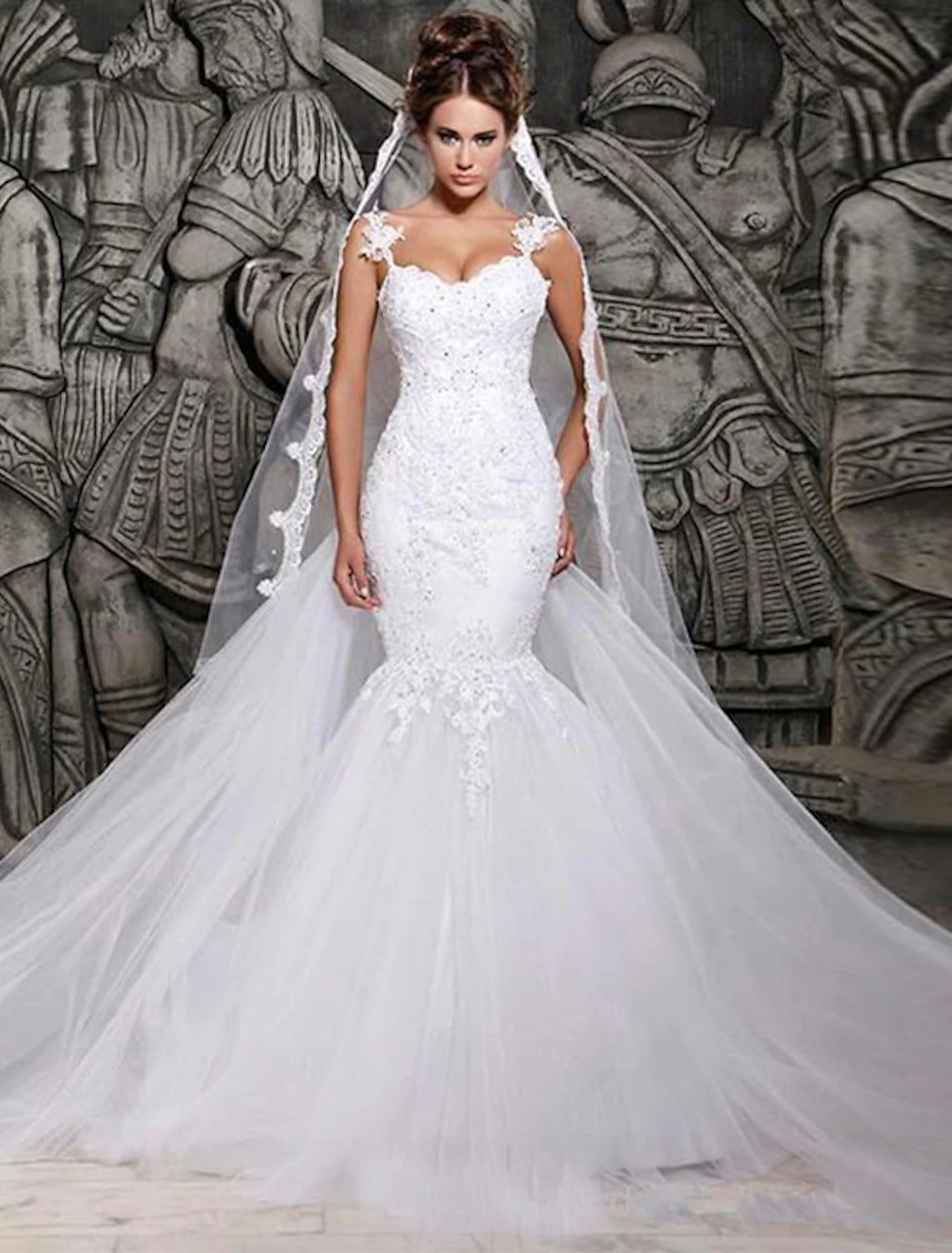 Elegant lace mermaid wedding dress with sweetheart neckline and cap sleeves.