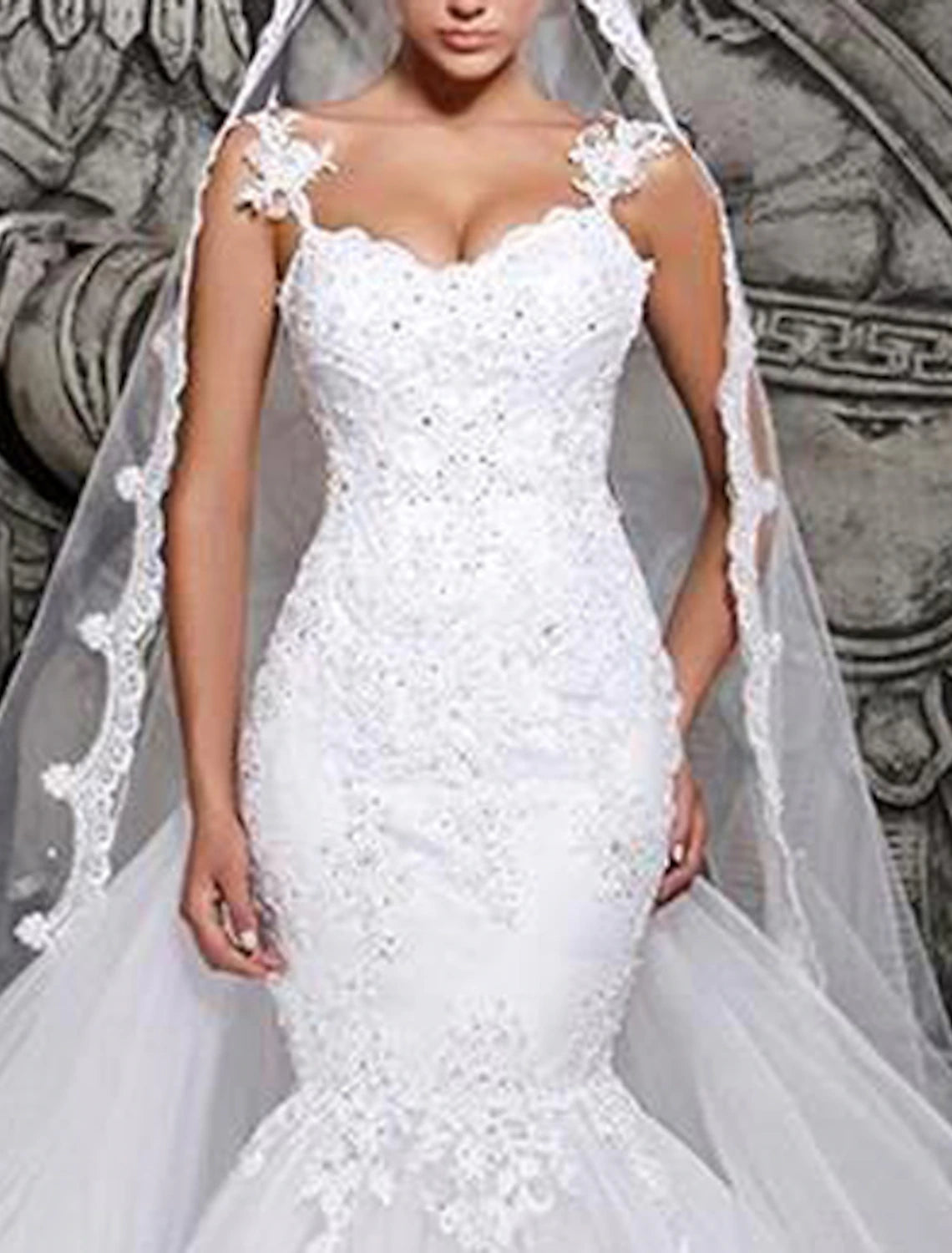 Side profile of a bride wearing a lace mermaid wedding gown.