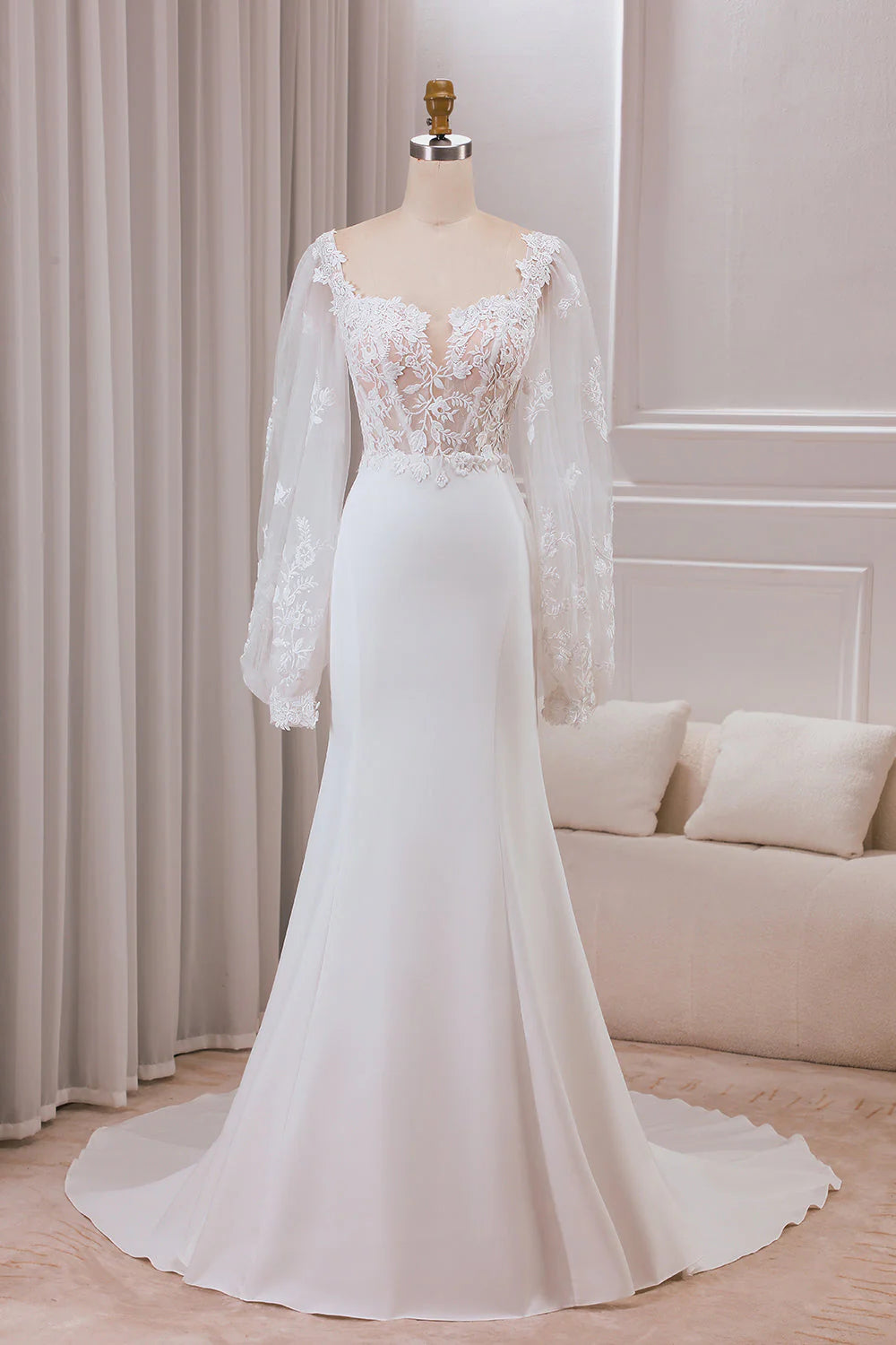 Elegant mermaid lace wedding dress with sweetheart neckline and long sleeves.