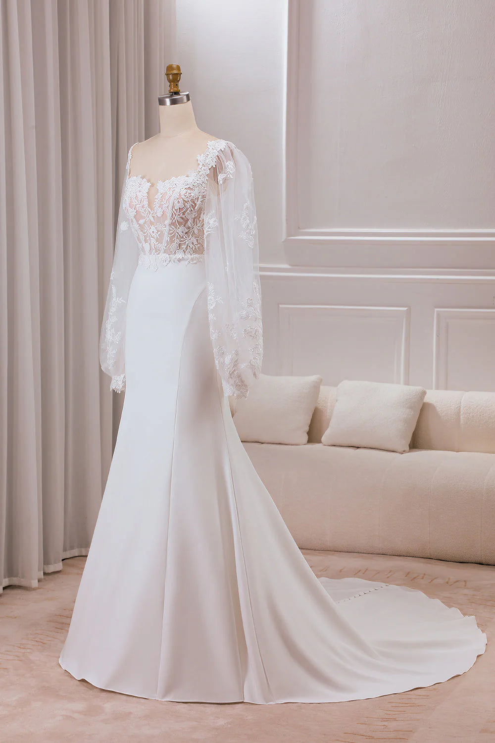 Close-up of lace long sleeves and sweetheart neckline on wedding gown.