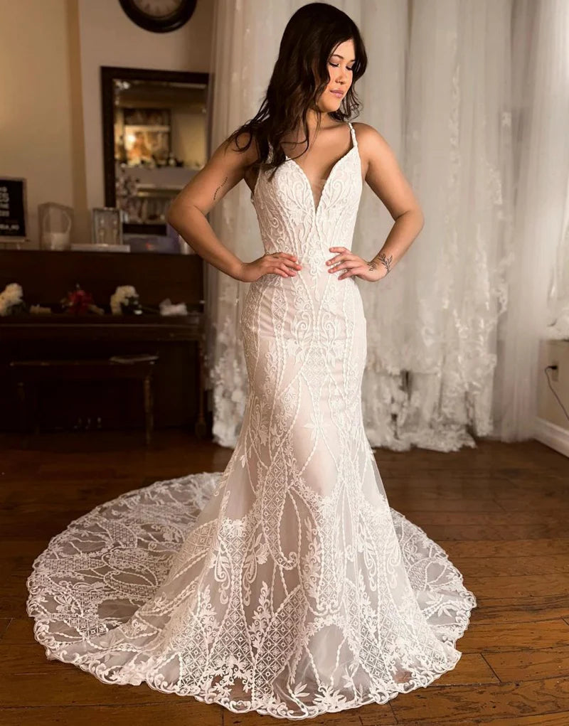 Back view of a mermaid wedding dress with lace details and a court train.