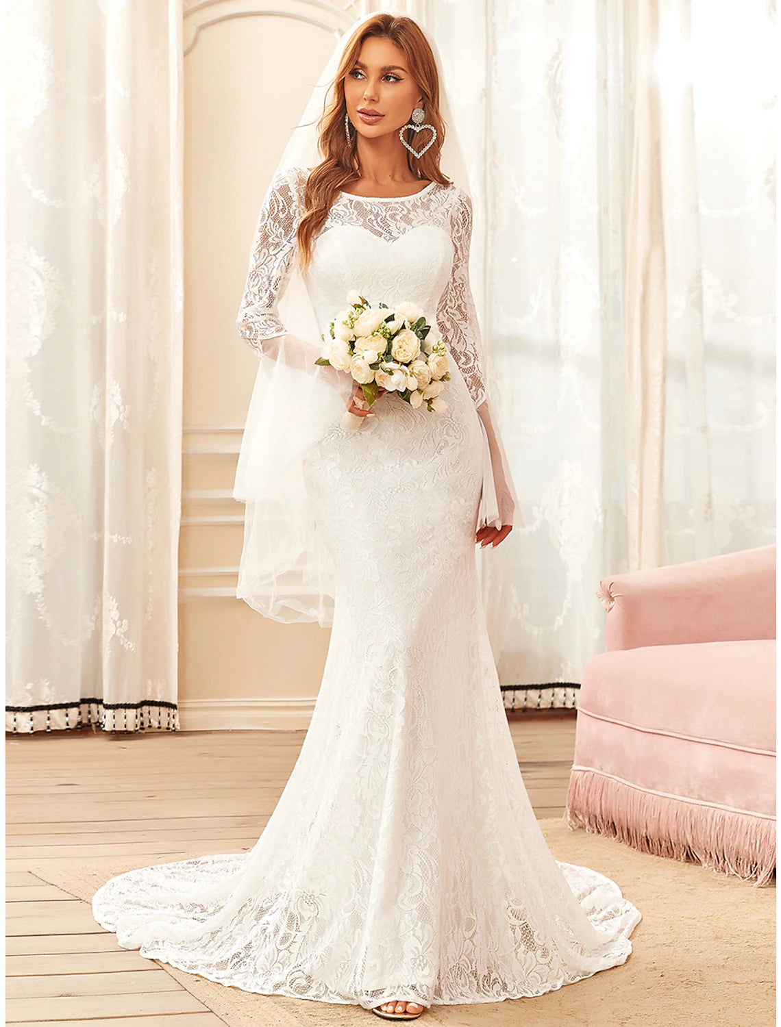 Front view of an elegant white lace mermaid wedding dress with long illusion sleeves and a sweep train.