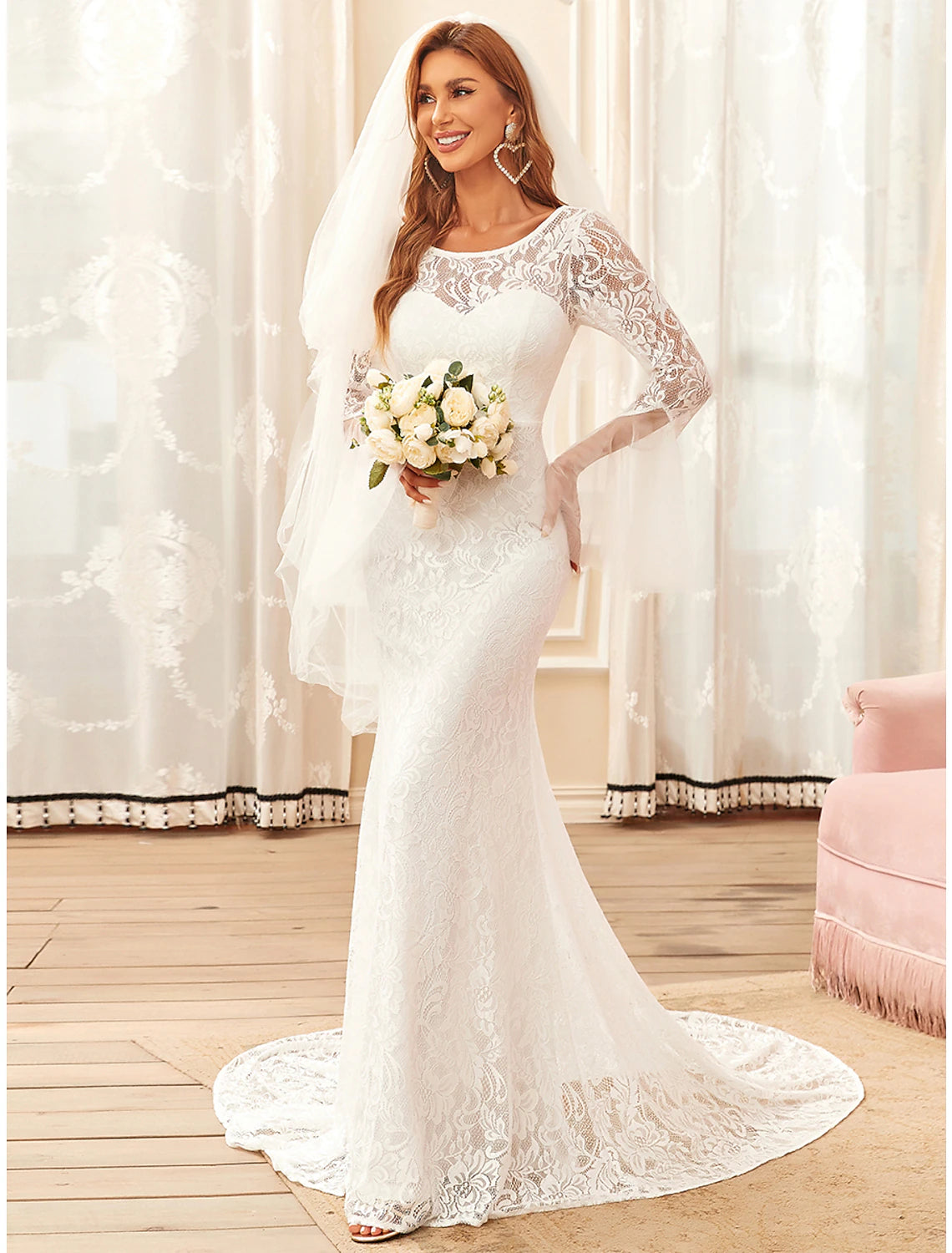 Side view of a bride wearing a boho lace mermaid wedding dress with an illusion neckline.