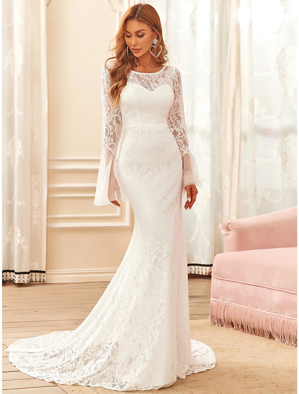 Back view of the mermaid wedding dress showcasing the sweep train and lace pattern.