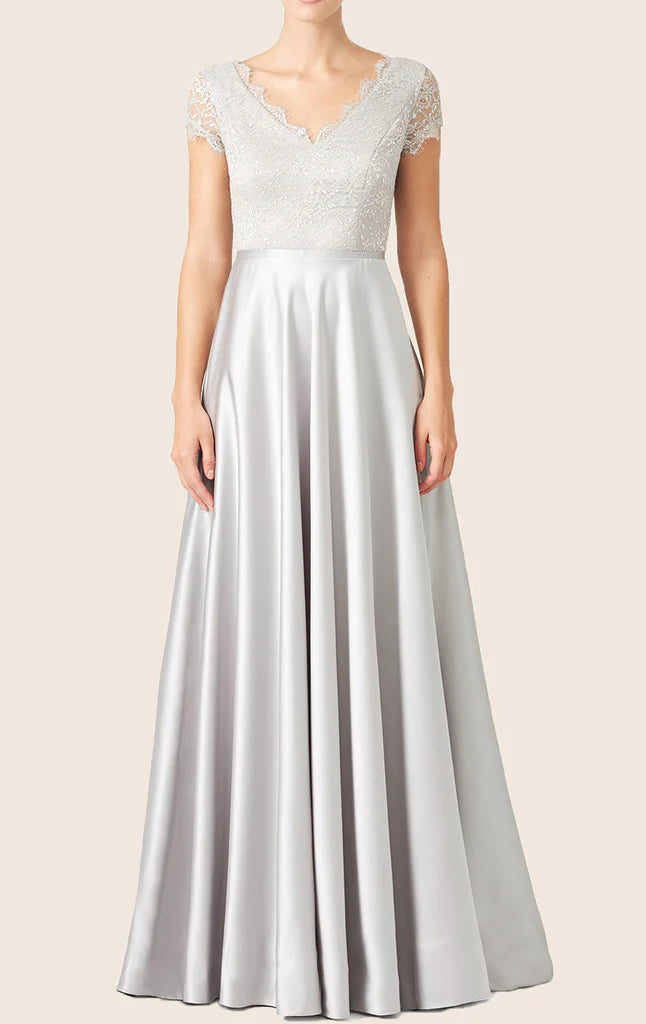 Elegant woman wearing a light-colored lace and satin formal maxi gown.