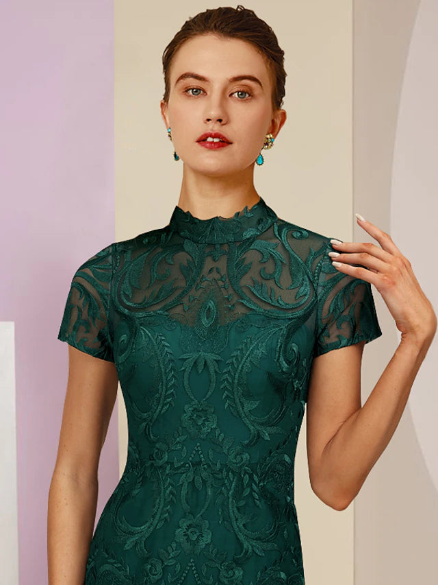 Back view of an elegant lace sheath dress with appliques and short sleeves.