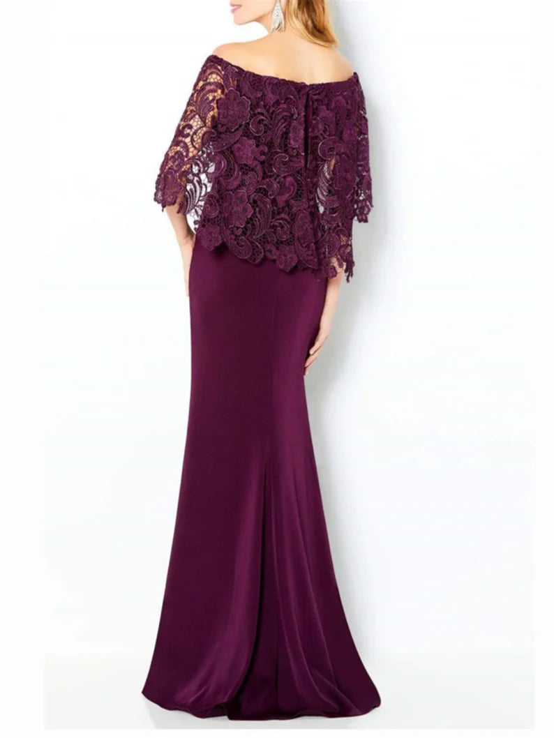 Woman wearing a formal off-shoulder lace dress.