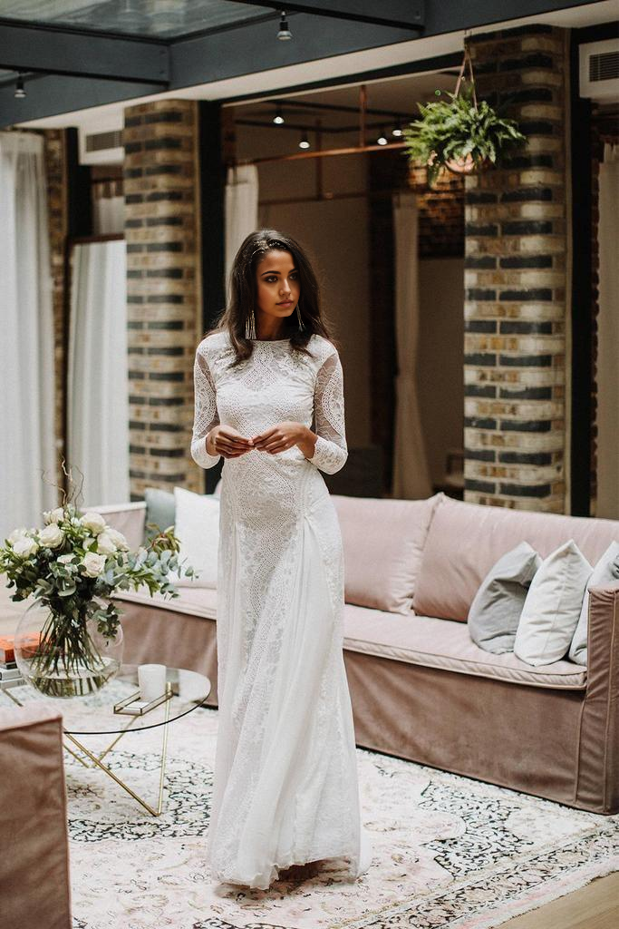 Back view of the wedding dress showcasing the elegant open back design.