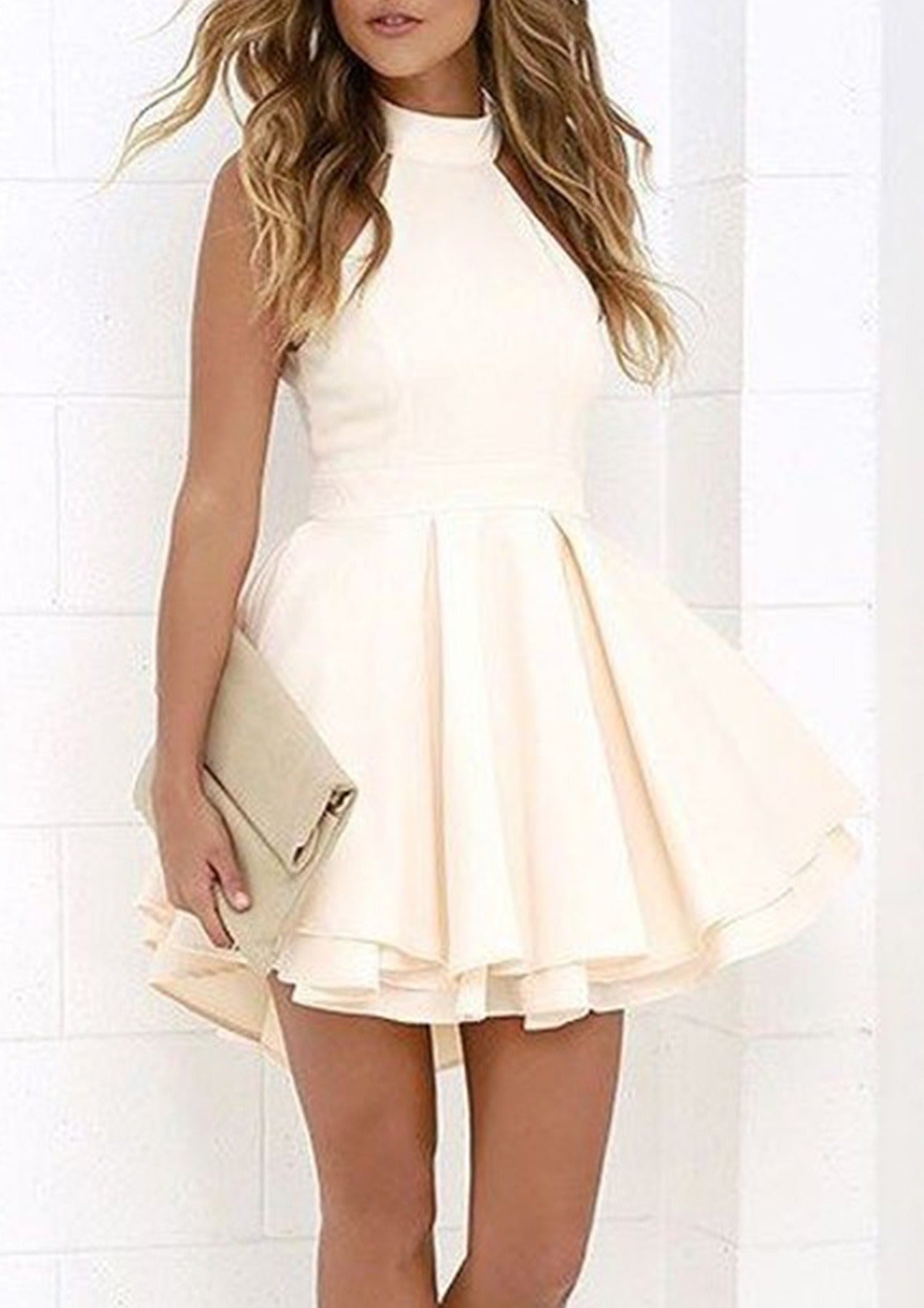 Model wearing an elegant ivory halter neck A-line short homecoming dress with a layered skirt.