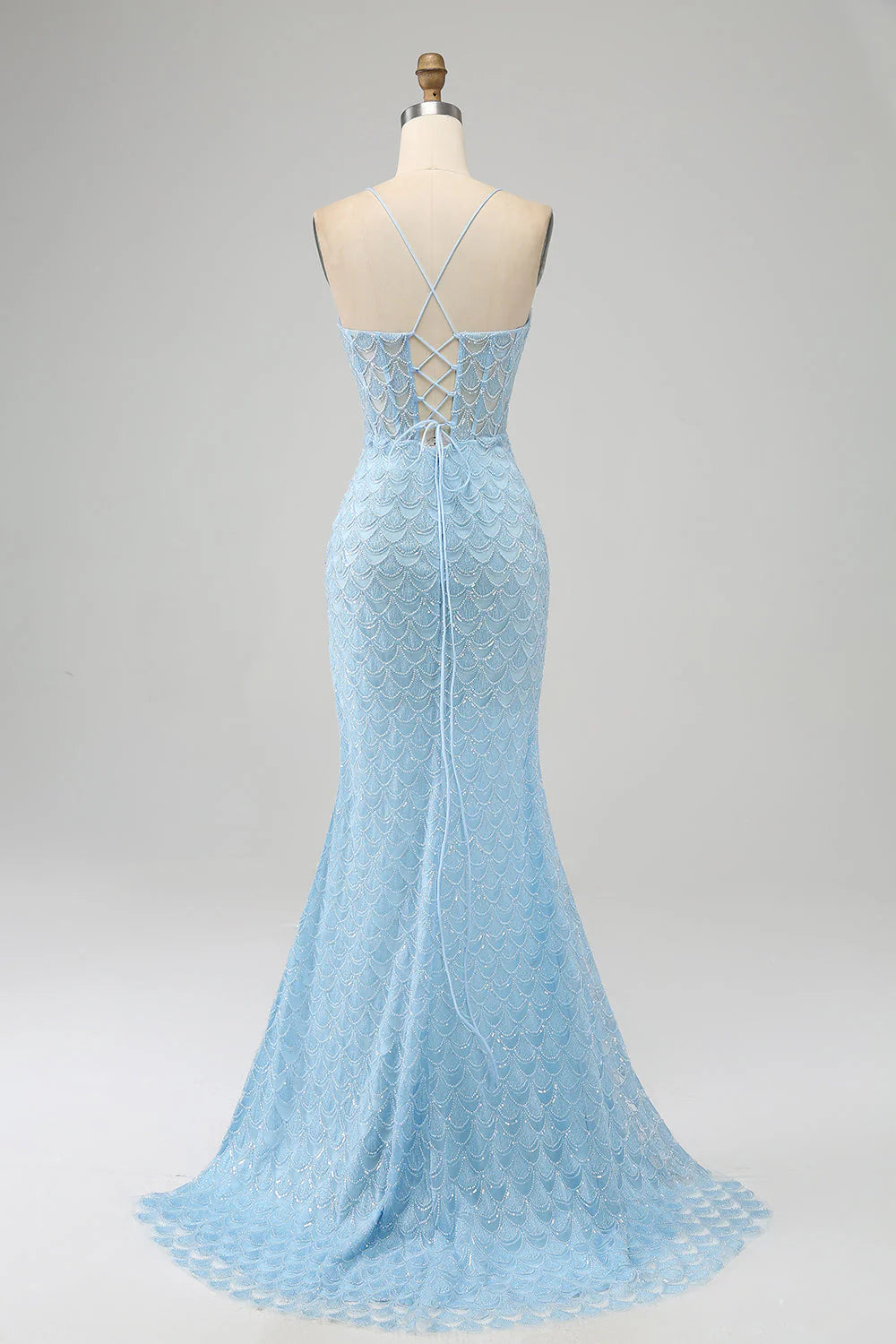 Side view of a light blue mermaid prom dress with ruched details.