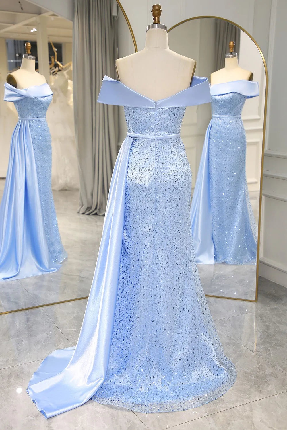 Back view of light blue mermaid prom dress with elegant train.