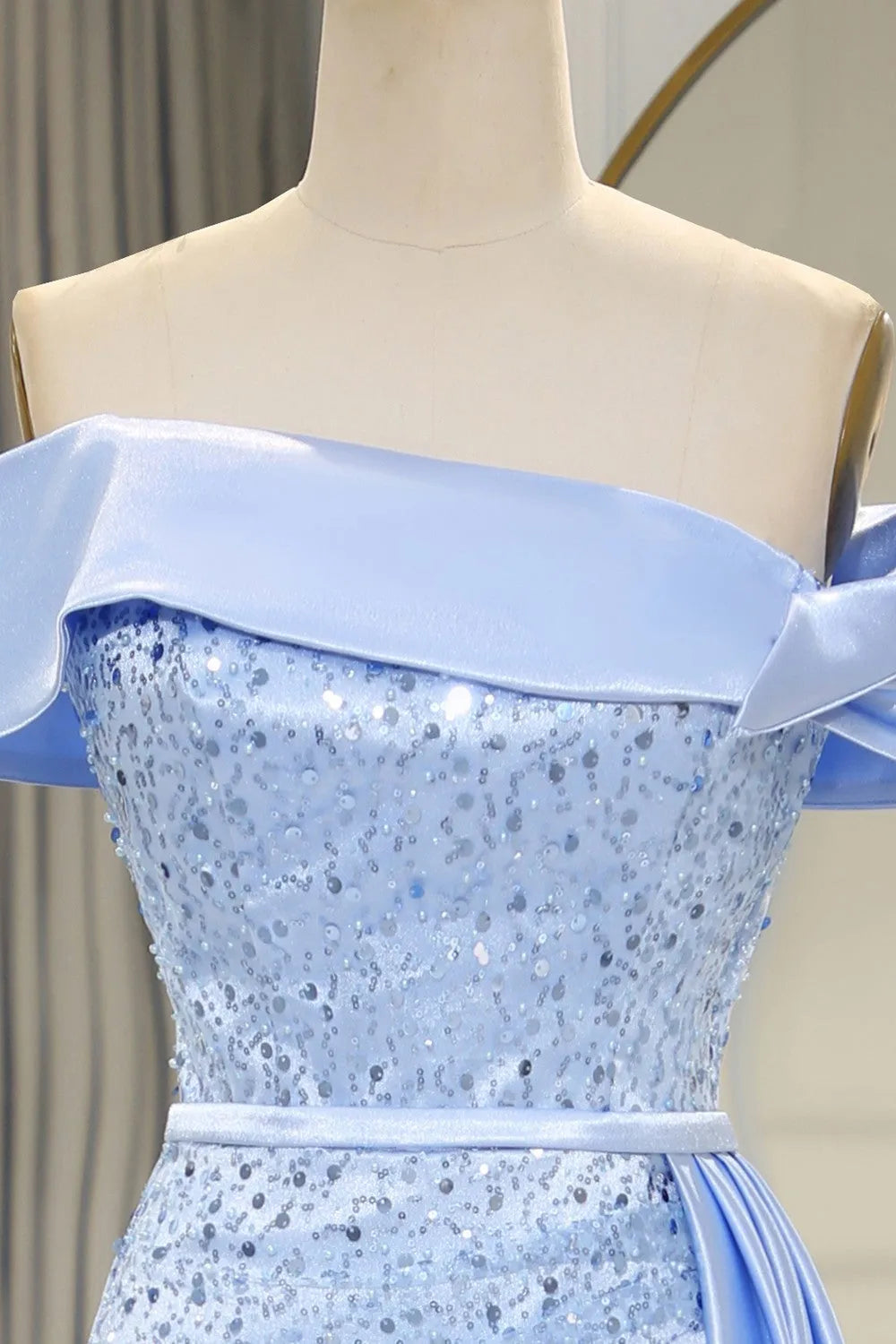 Side view of light blue off-shoulder mermaid dress with split.