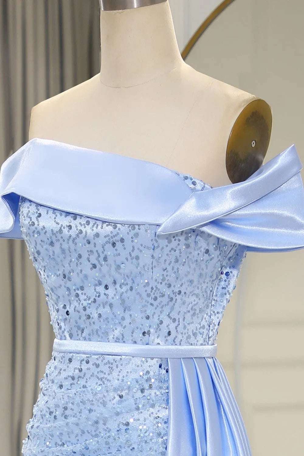 Close-up of the off-shoulder neckline on a light blue mermaid gown.
