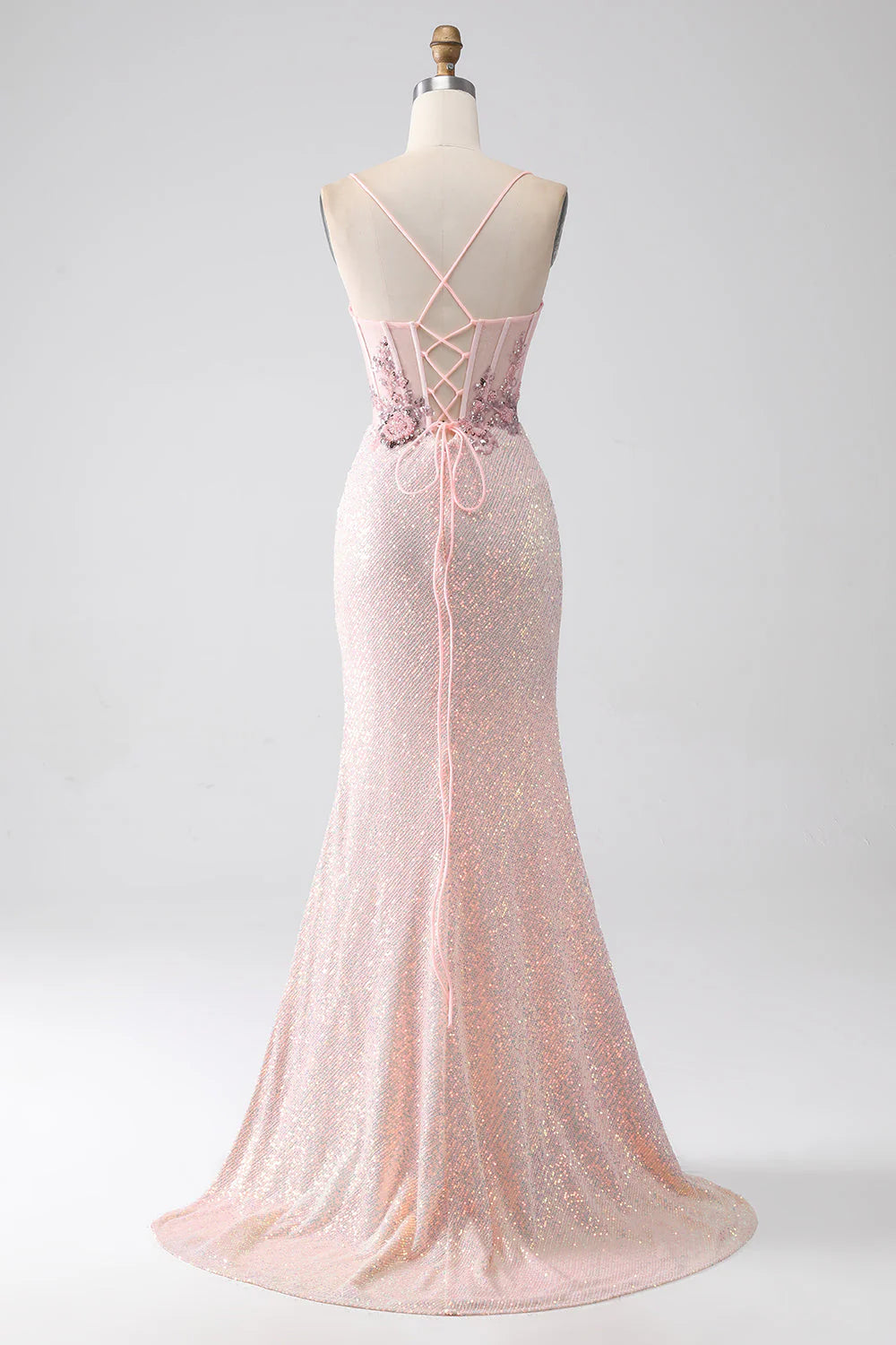 Side view of an elegant light pink mermaid gown, showcasing the flowing silhouette.