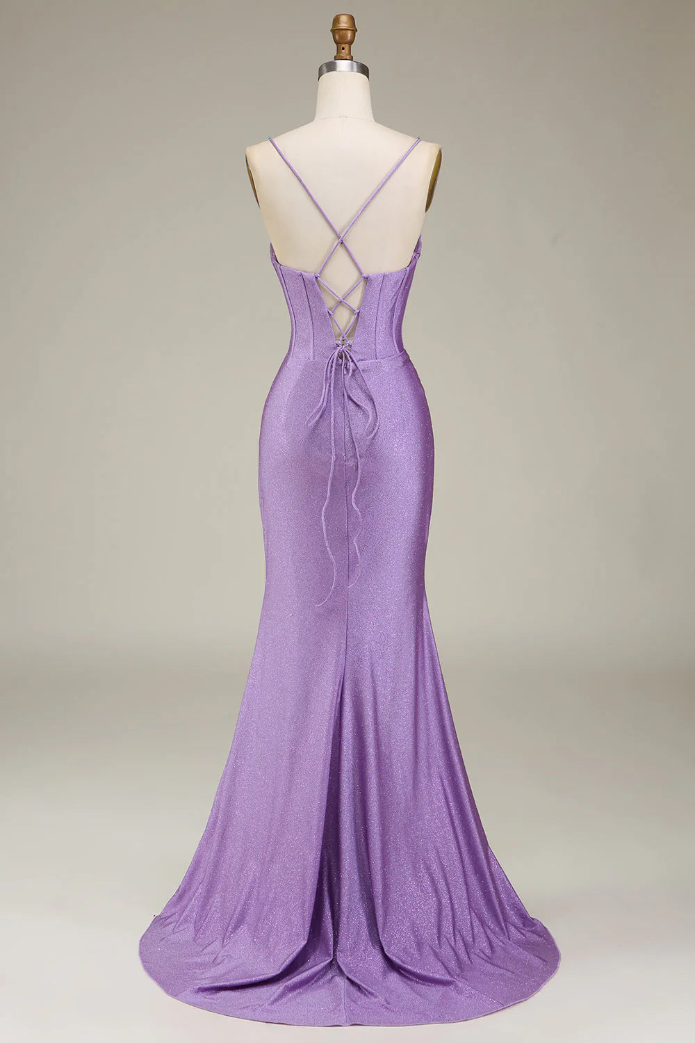 Back view of a woman wearing a lilac A-line prom dress with a flowing skirt.