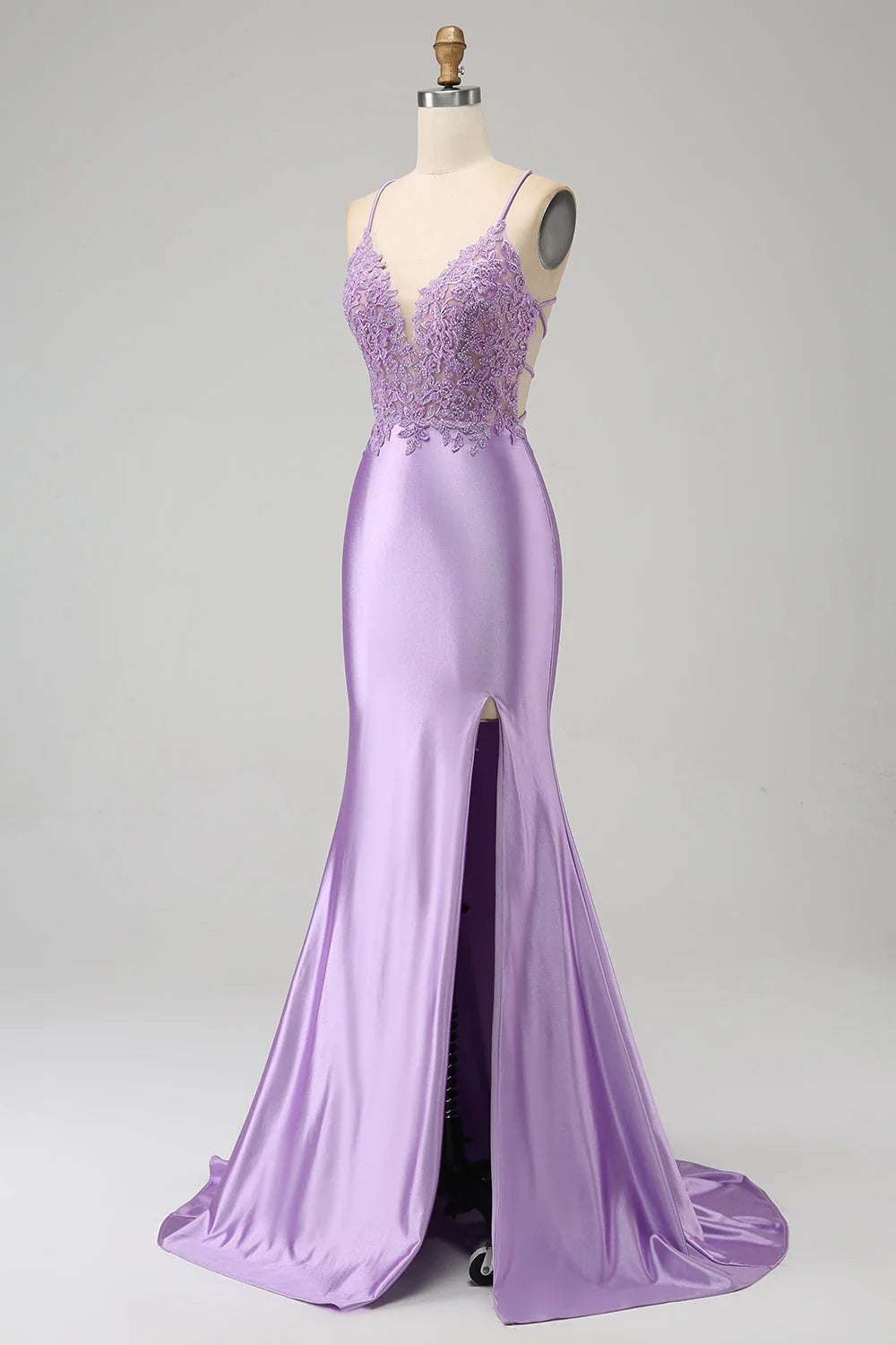 Side view of lilac mermaid prom dress highlighting the slit and appliques.