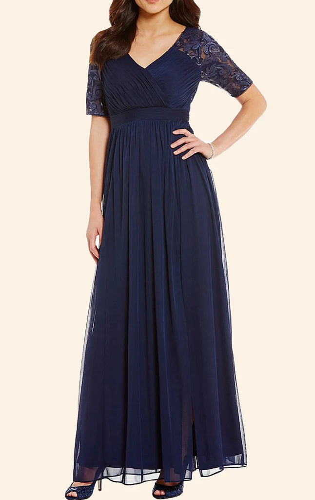 Woman wearing an elegant long lace and chiffon Mother of the Bride dress with short sleeves.