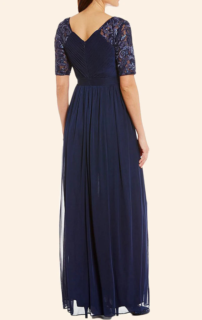 Side view of a woman in a long lace and chiffon Mother of the Bride dress.