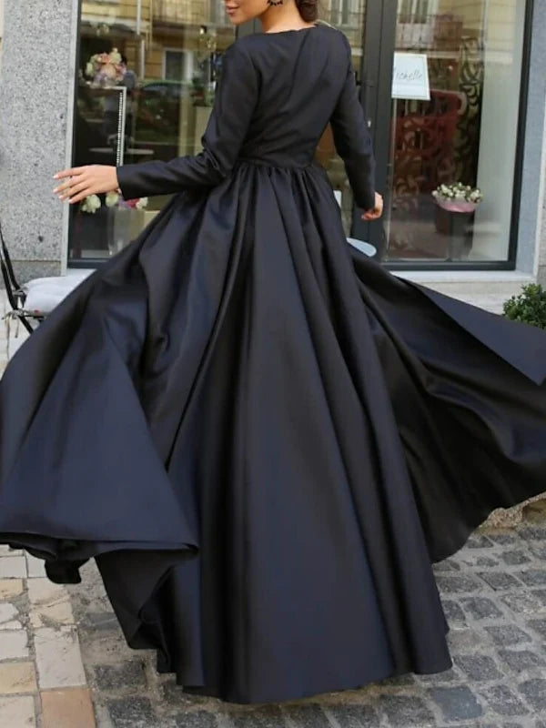 Back view of the long sleeve ball gown, showcasing the elegant sweep train.