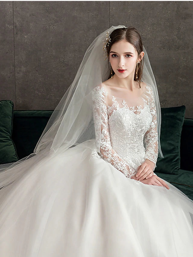 Close-up of the illusion lace neckline and long sleeves on a wedding dress.