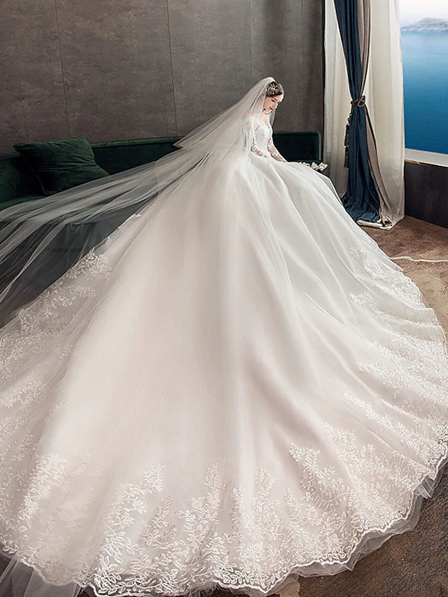 Detail of the lace appliques and fabric texture on the wedding gown.