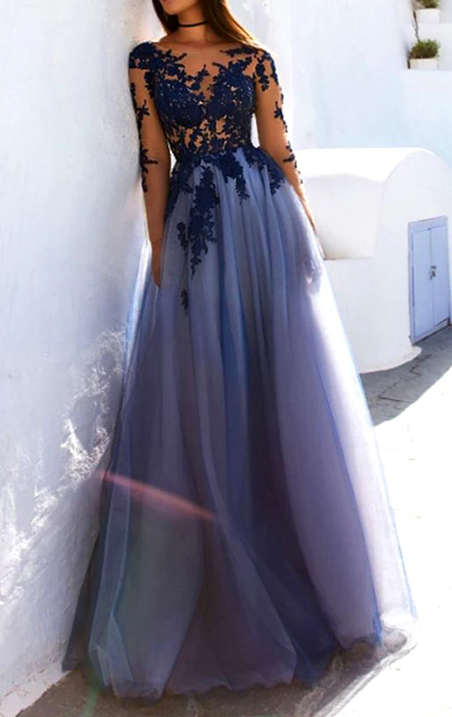 Woman wearing an elegant long sleeve lace and tulle formal evening gown.