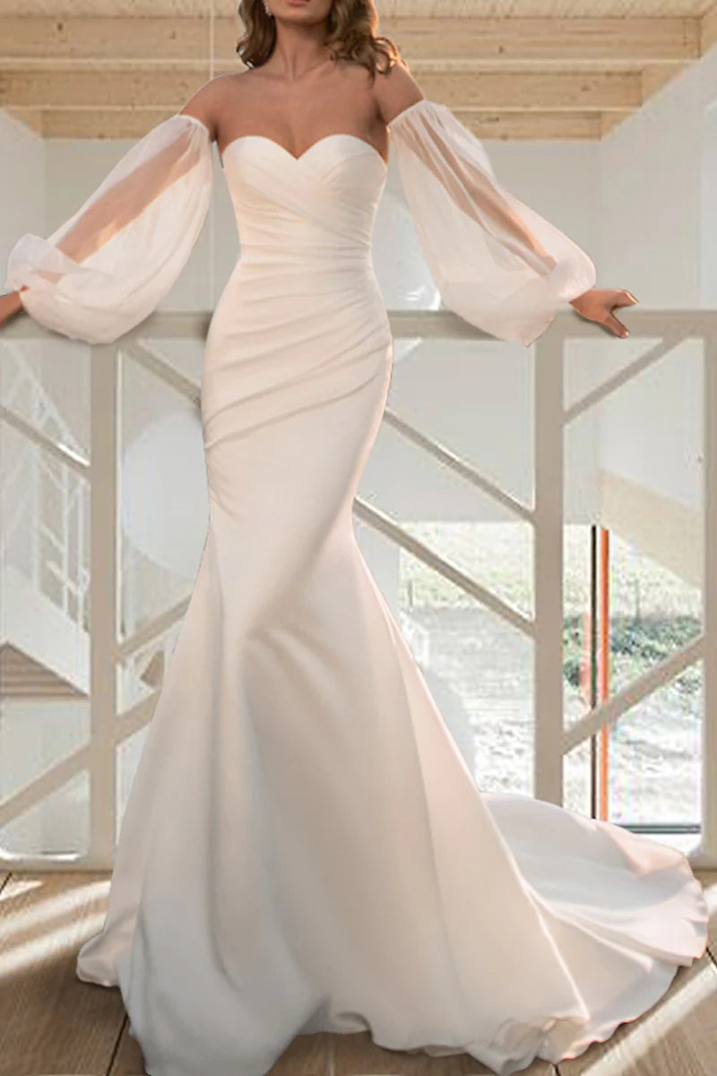 Elegant long sleeve mermaid trumpet wedding dress, front view.