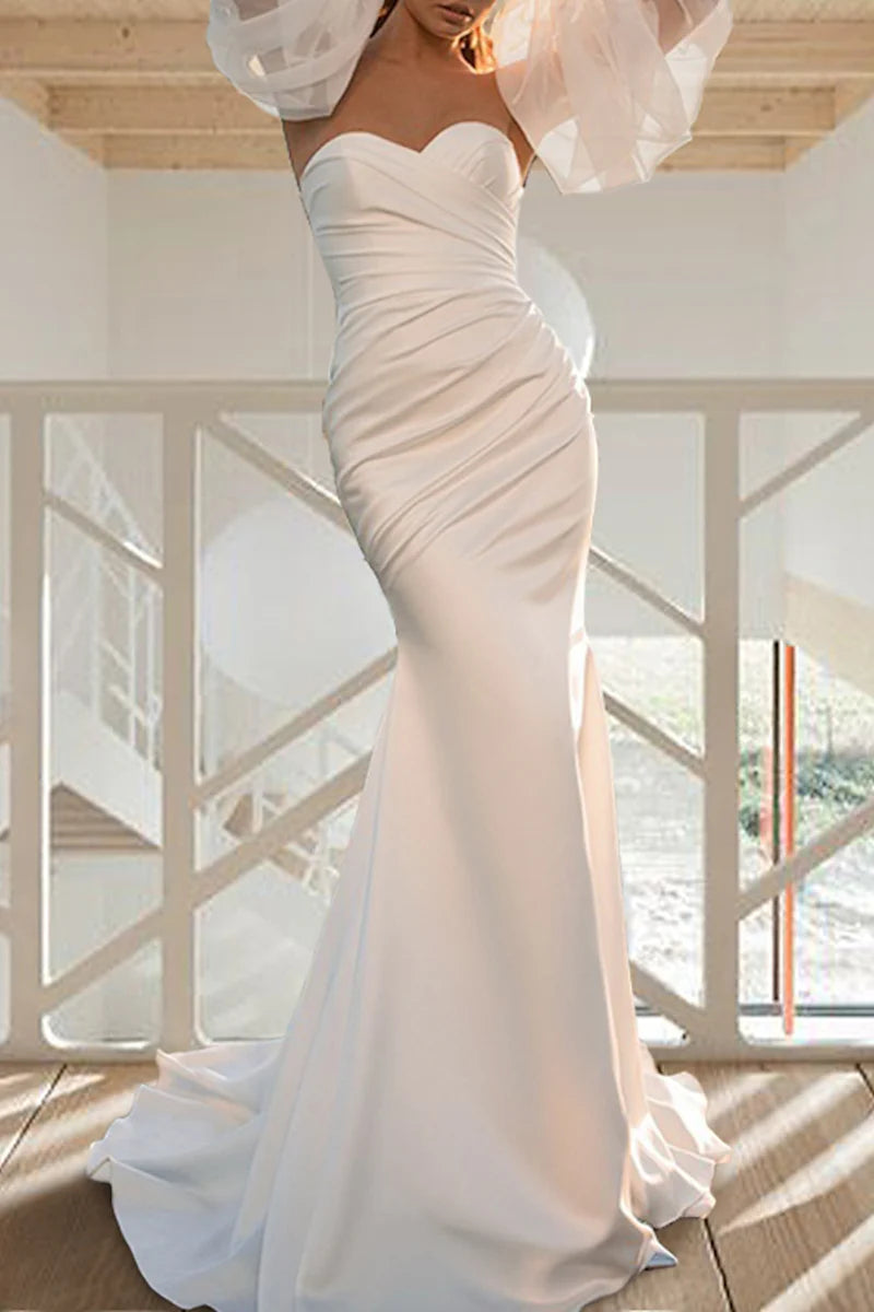 Close-up of the long sleeves and bodice details of the wedding dress.