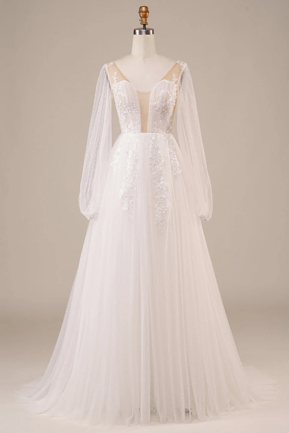 Elegant ivory long sleeve wedding dress with open back and floral appliques.