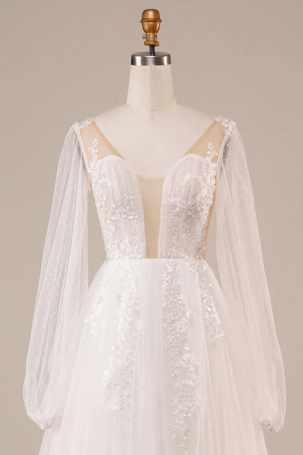 Side view of bridal gown with long sleeves and intricate appliques.